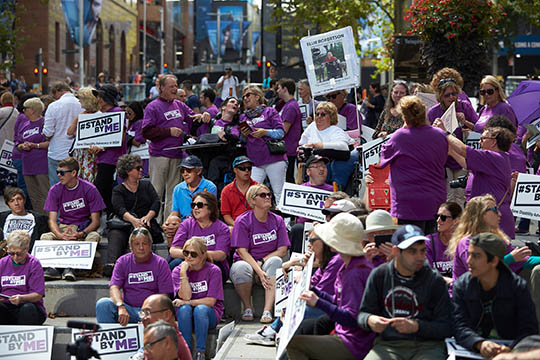 People holding Stand By Me signs