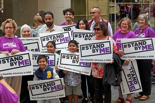 People holding Stand By Me signs