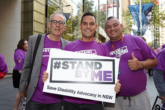 People holding Stand By Me signs