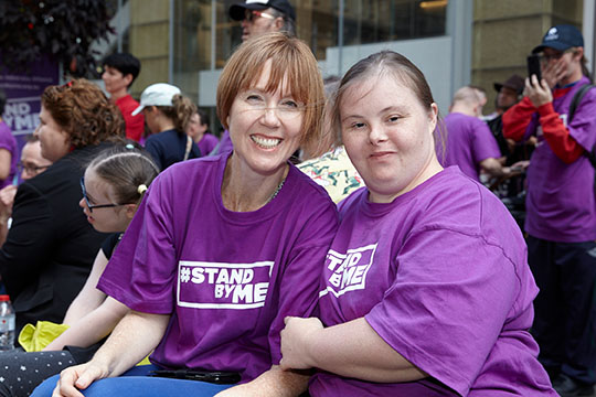People holding Stand By Me signs