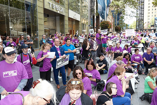 People holding Stand By Me signs