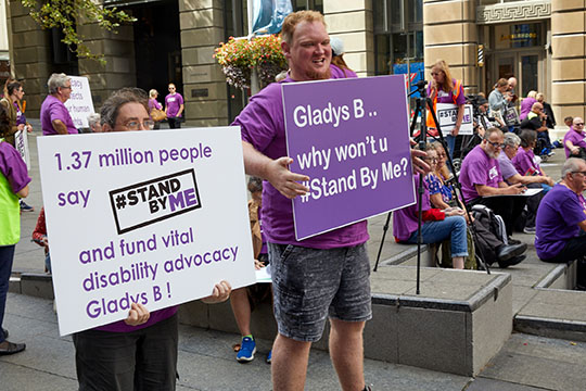 People holding Stand By Me signs