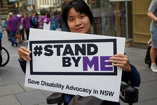 Person holding A Stand By Me sign
