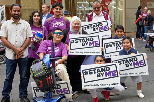 People holding Stand By Me signs