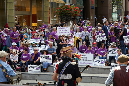 People holding Stand By Me signs