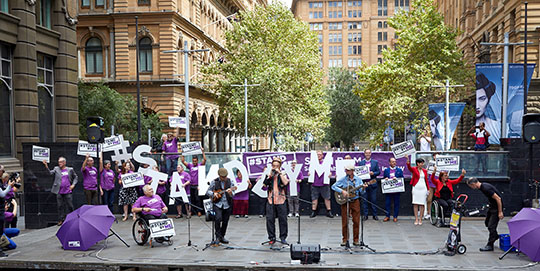 People holding Stand By Me signs