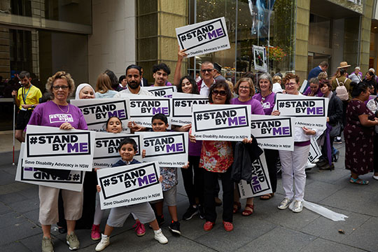 People holding Stand By Me signs