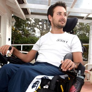 Man using motorised wheelchair on his porch